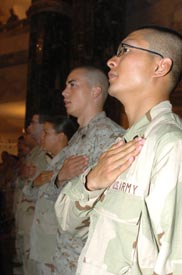 soldiers hold their hands to their hearts while saying the pledge of allegiance